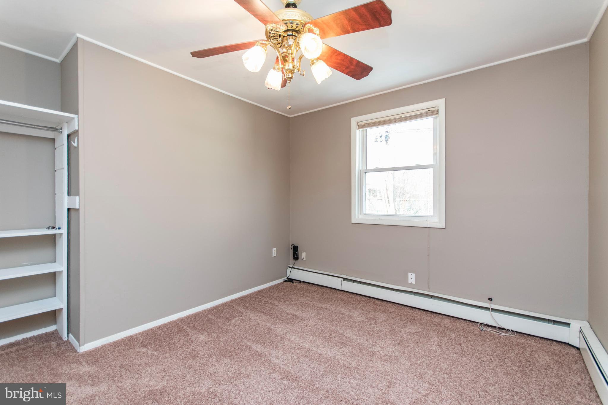 32 Gentle Road Levittown, PA 19057 - Photo 23 of 32 an empty room with a window and a ceiling fan