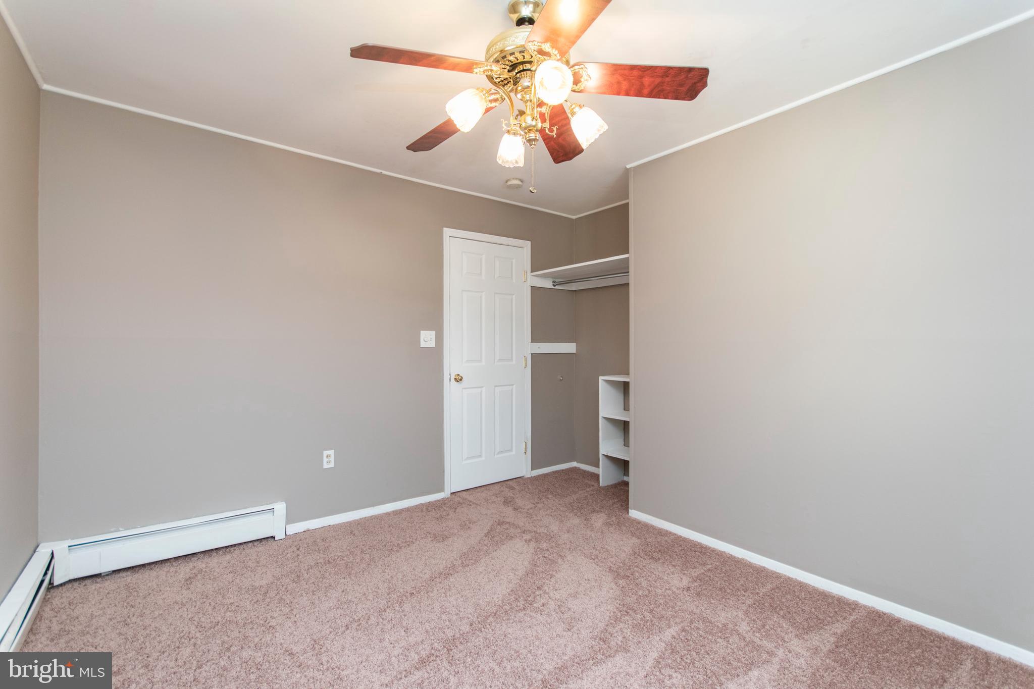32 Gentle Road Levittown, PA 19057 - Photo 24 of 32 an empty room with a chandelier fan and windows