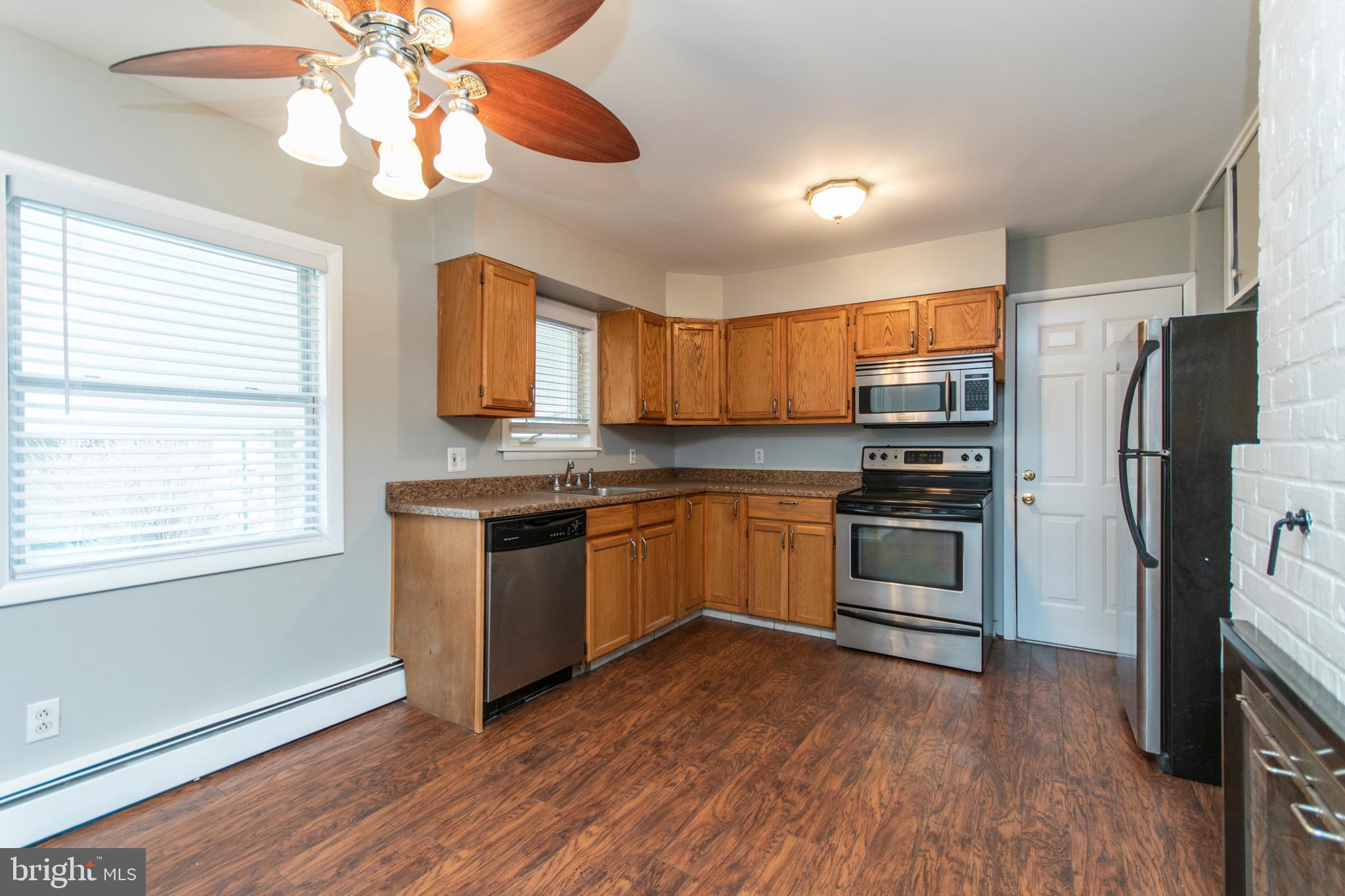 32 Gentle Road Levittown, PA 19057 - Photo 4 of 32 a kitchen with a refrigerator cabinets and wooden floor