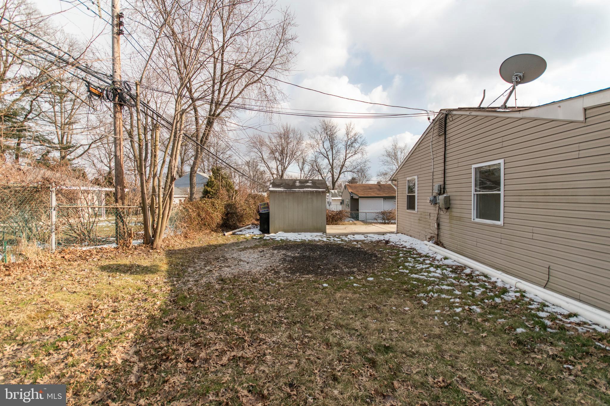 32 Gentle Road Levittown, PA 19057 - Photo 31 of 32 a backyard of a house with garage and parked