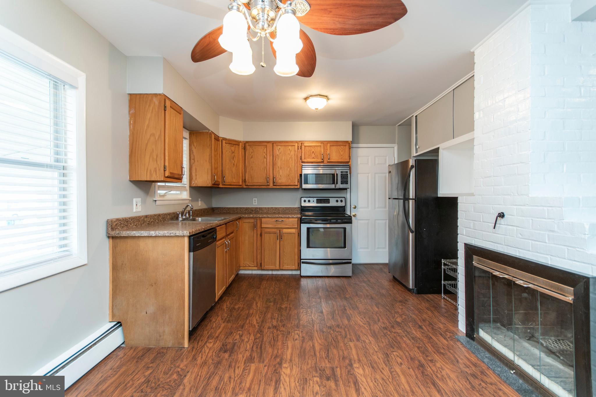 32 Gentle Road Levittown, PA 19057 - Photo 5 of 32 a kitchen with a refrigerator a stove top oven a sink dishwasher and wooden floor