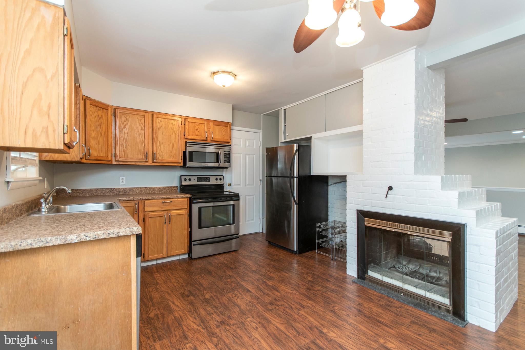 32 Gentle Road Levittown, PA 19057 - Photo 6 of 32 a kitchen with granite countertop stainless steel appliances and wooden cabinets