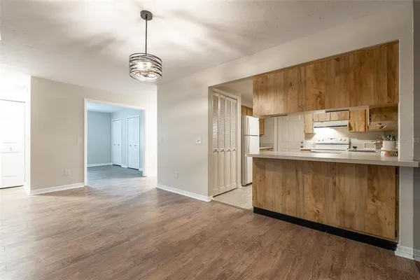 a view of kitchen with granite countertop cabinets and wooden floor