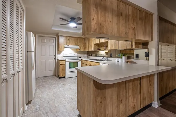 a kitchen with kitchen island a sink stove and refrigerator