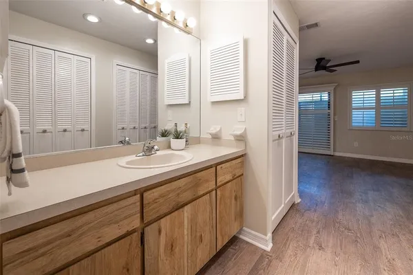 a bathroom with a sink double vanity granite tub and shower