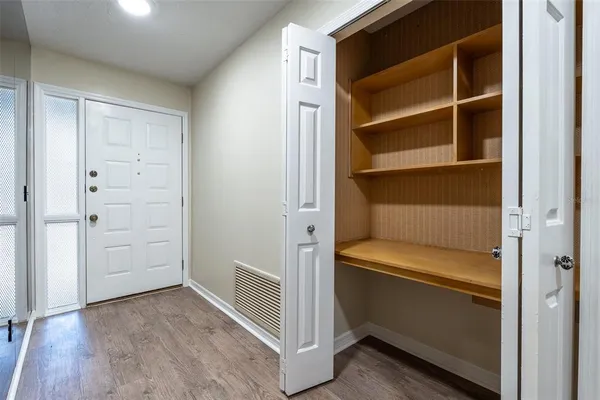 a view of walk in closet with empty racks