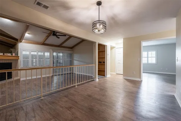 a view of a room with wooden floor