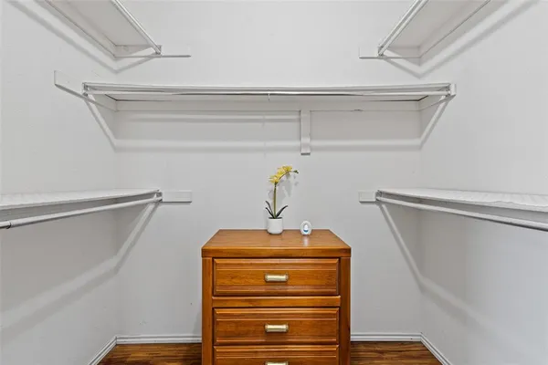 a view of walk in closet with clothes