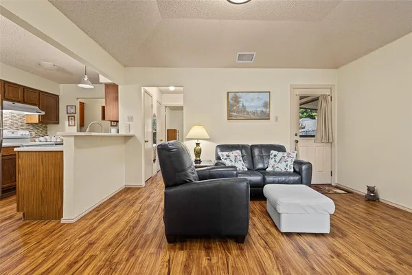 a living room with furniture and wooden floor