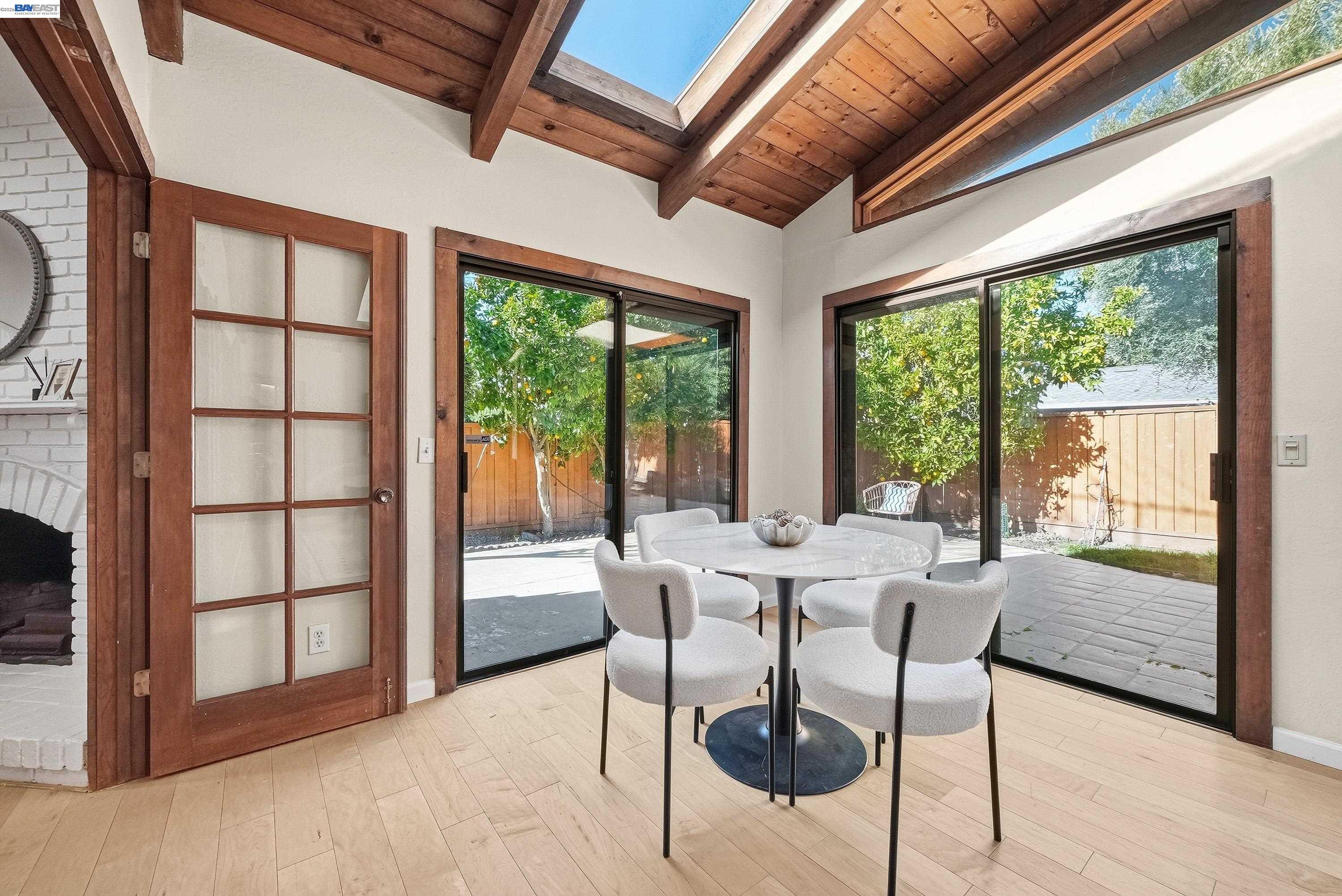 1621 Harvest Road Pleasanton, CA 94566 - Photo 19 of 52 a dining room with furniture window outside view and wooden floor