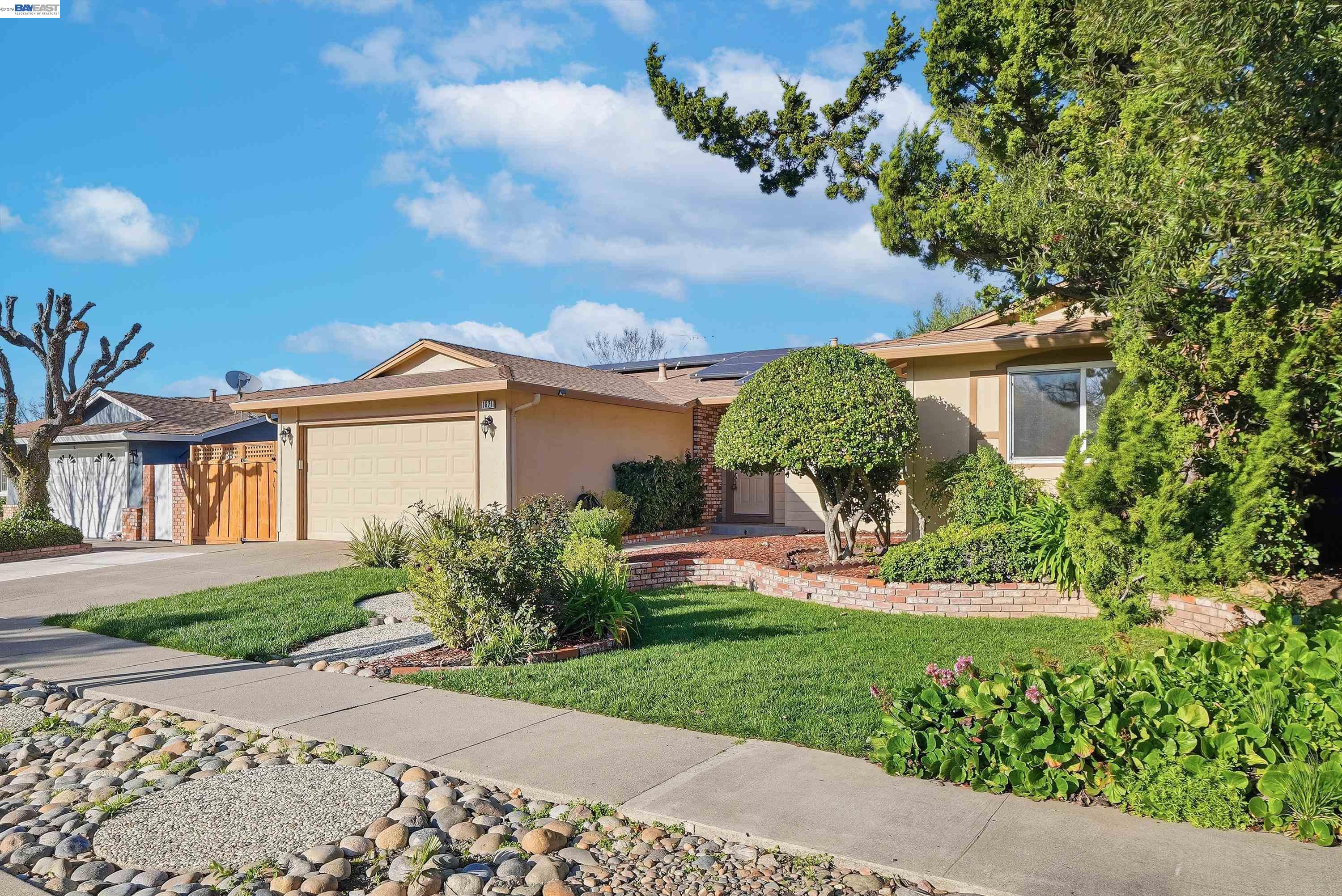 1621 Harvest Road Pleasanton, CA 94566 - Photo 3 of 52 a front view of a house with a yard and potted plants
