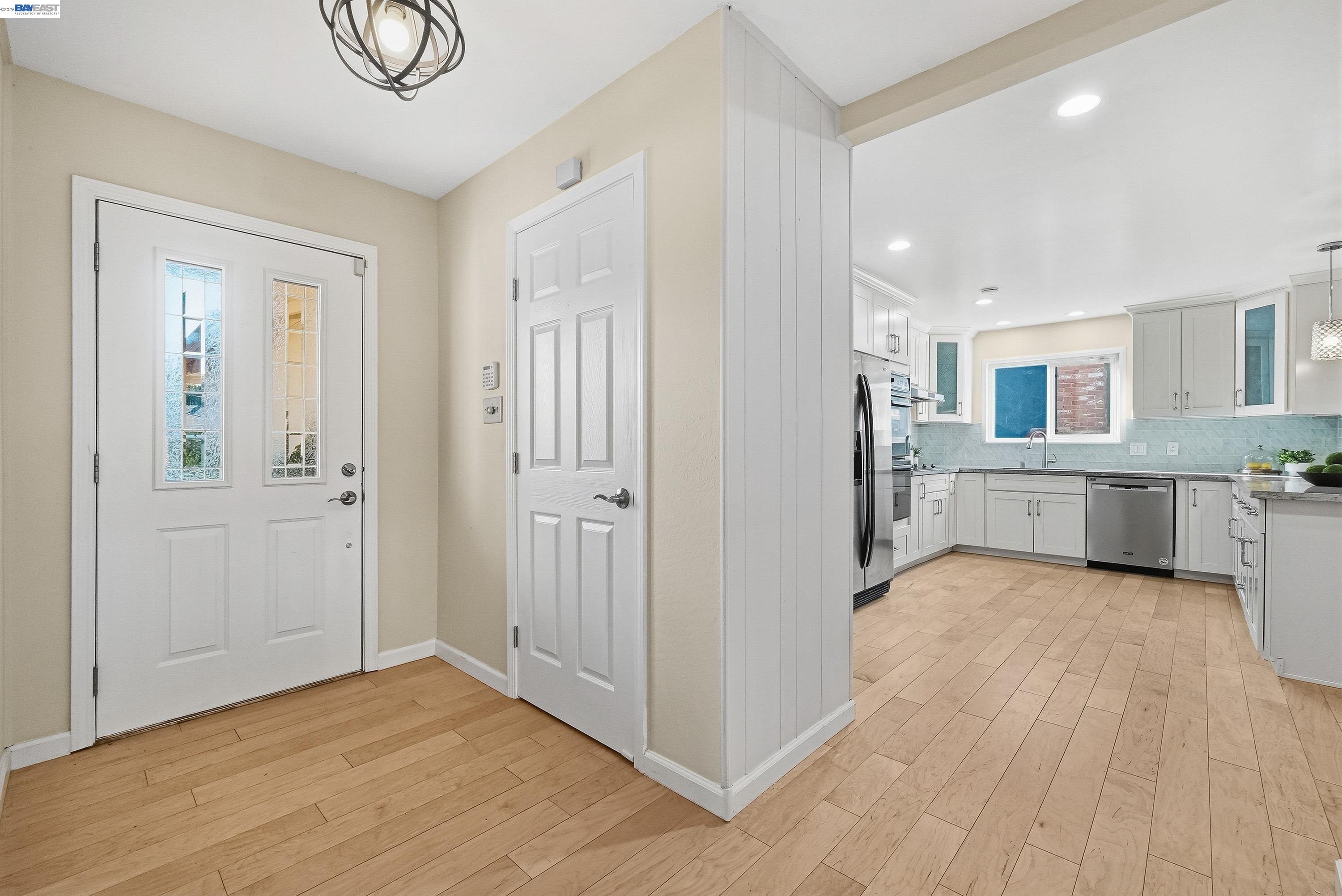 1621 Harvest Road Pleasanton, CA 94566 - Photo 10 of 52 a view of a kitchen with an entryway and wooden floor