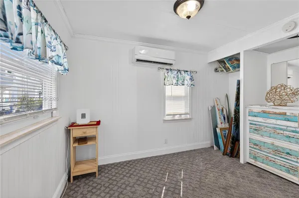a view of a storage & utility room with closet window