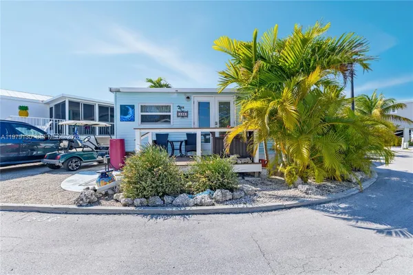 a front view of a house with a yard and a garage
