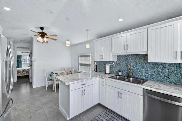 a kitchen that has a sink and a stove top oven