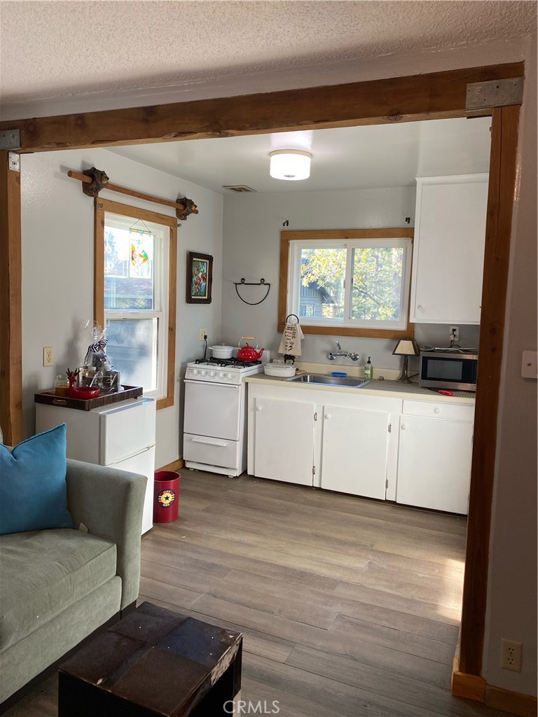 2726 View Drive Running Springs, CA 92382 - Photo 16 of 17 a kitchen with a sink cabinets and wooden floor