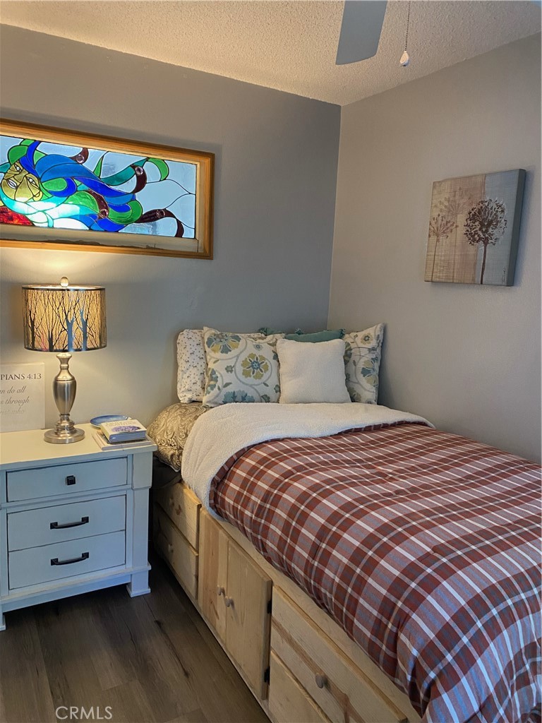 2726 View Drive Running Springs, CA 92382 - Photo 17 of 17 a bedroom with a bed and wooden floor