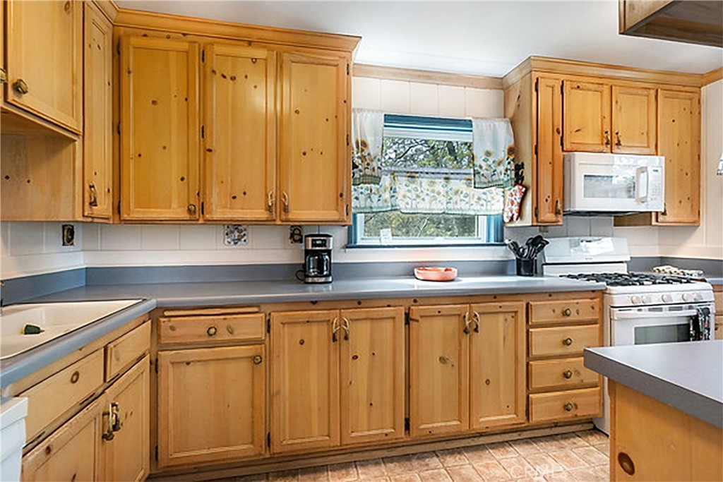 2726 View Drive Running Springs, CA 92382 - Photo 2 of 17 a kitchen with appliances cabinets and a window