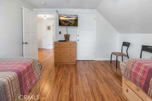 2726 View Drive Running Springs, CA 92382 - Photo 4 of 17 a bedroom with a bed and a flat screen tv