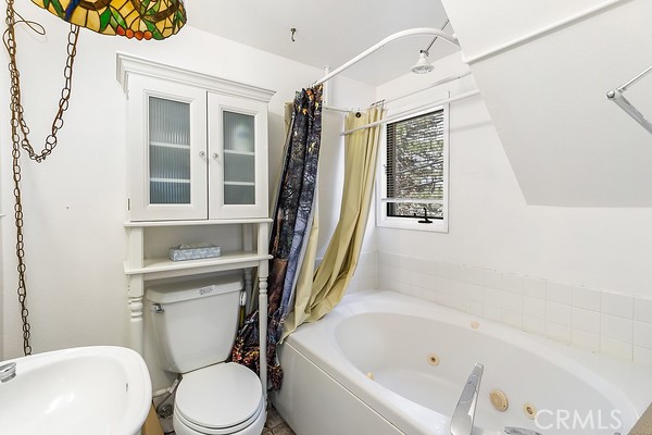 2726 View Drive Running Springs, CA 92382 - Photo 5 of 17 a white bath tub sitting next to a white toilet