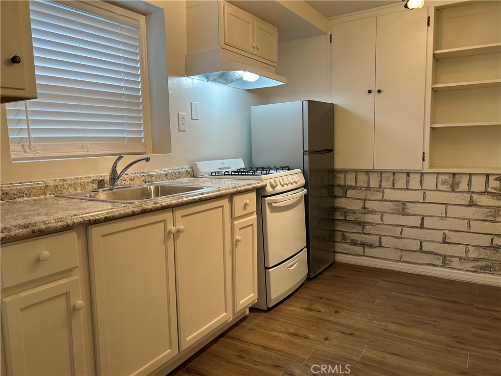 2726 View Drive Running Springs, CA 92382 - Photo 8 of 17 a kitchen with sink cabinets and wooden floor