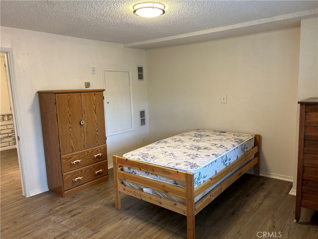 2726 View Drive Running Springs, CA 92382 - Photo 9 of 17 a bedroom with a bed and a dresser