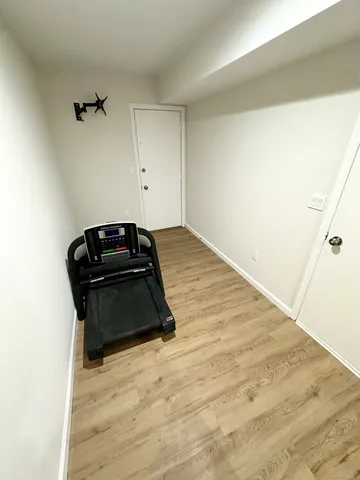 a room with a hardwood and dresser