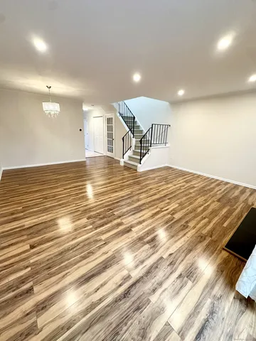 a view of a room with wooden floor