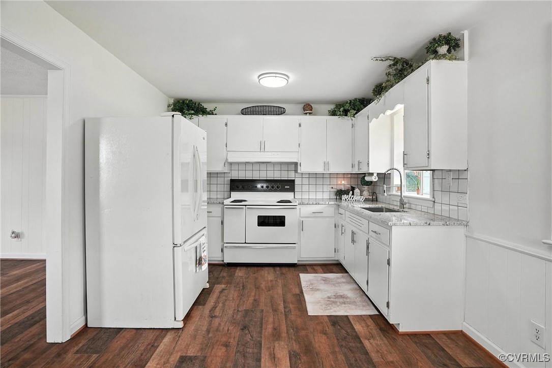 1822 Baughan Road Meherrin, VA 23954 - Photo 12 of 50 a kitchen with granite countertop a refrigerator oven a sink dishwasher and white cabinets with wooden floor