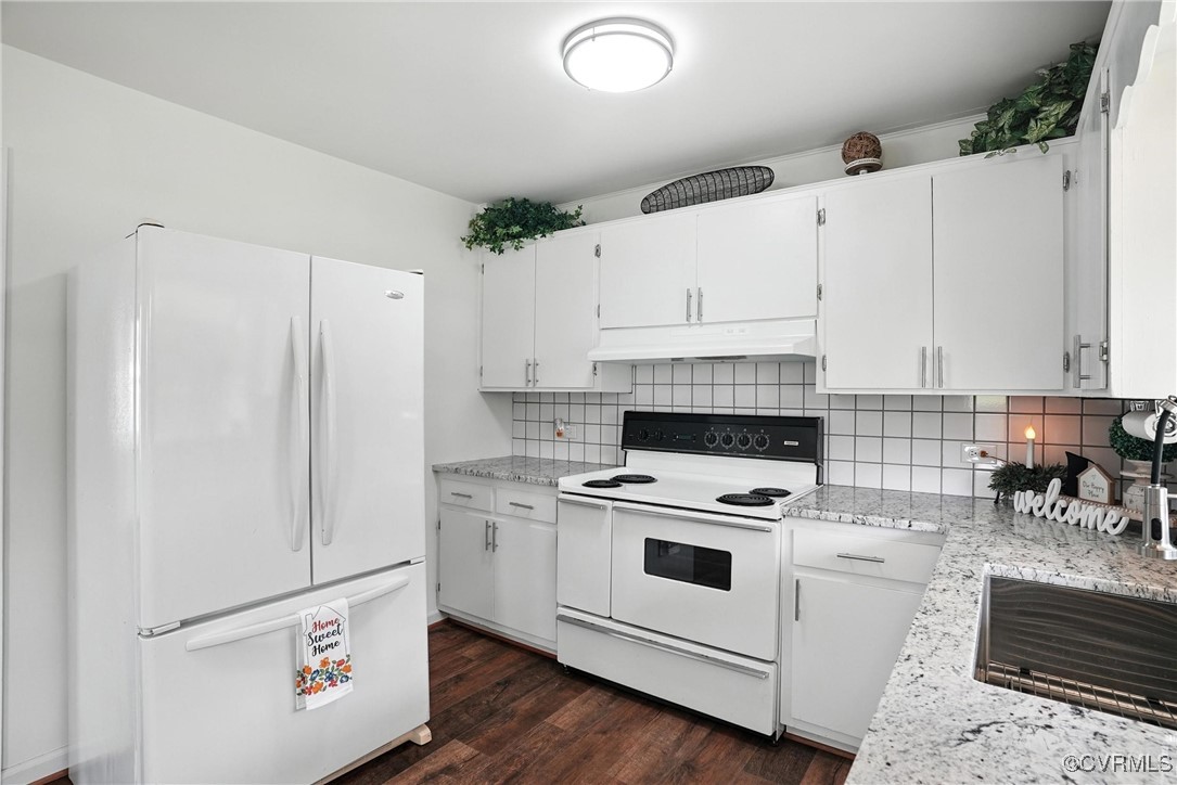 1822 Baughan Road Meherrin, VA 23954 - Photo 13 of 50 a kitchen with white cabinets and white appliances