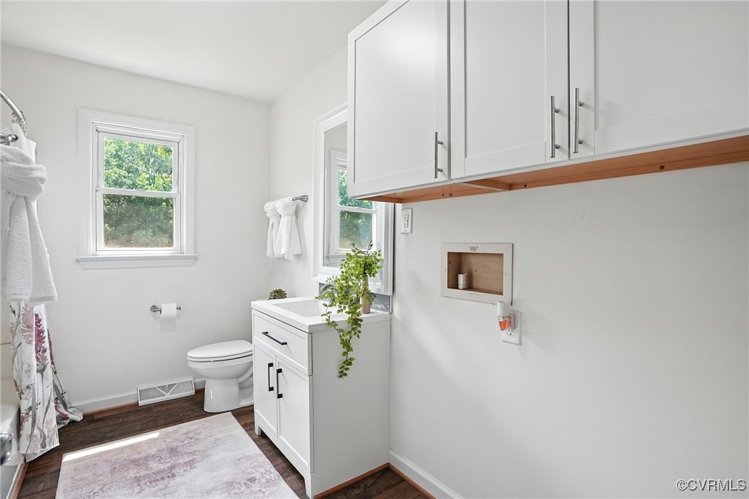 1822 Baughan Road Meherrin, VA 23954 - Photo 17 of 50 a bathroom with a toilet sink and mirror