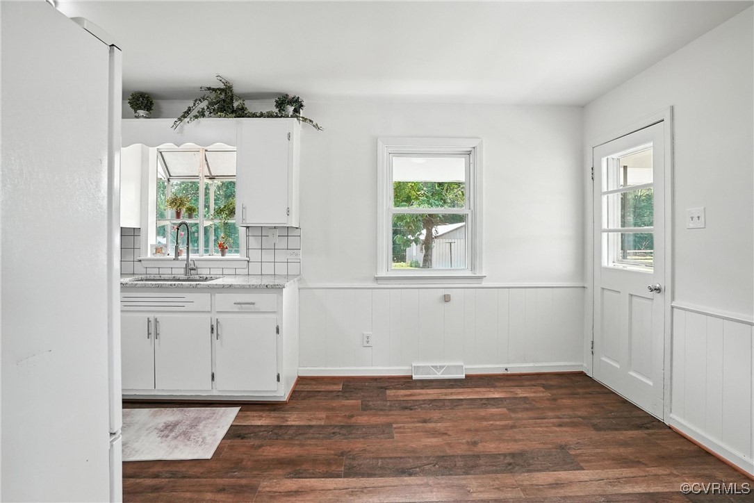 1822 Baughan Road Meherrin, VA 23954 - Photo 10 of 50 a view of a kitchen with wooden floor and a window