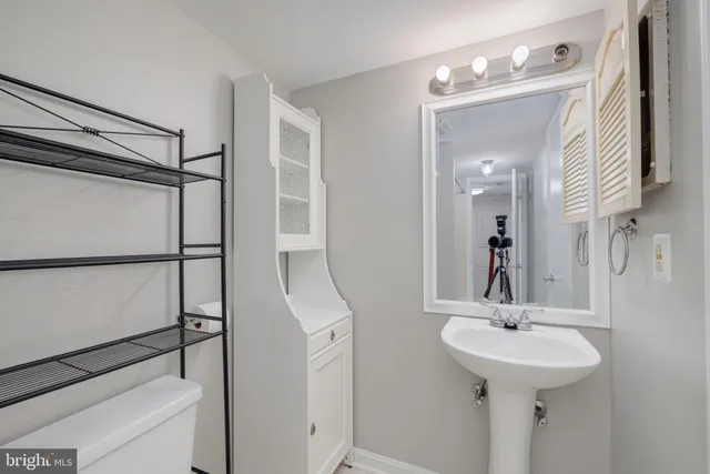 a bathroom with a sink a mirror and shower