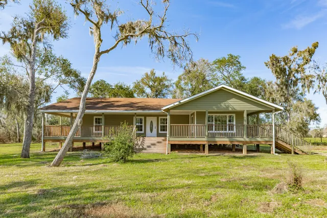 a view of a house with a backyard porch and sitting area