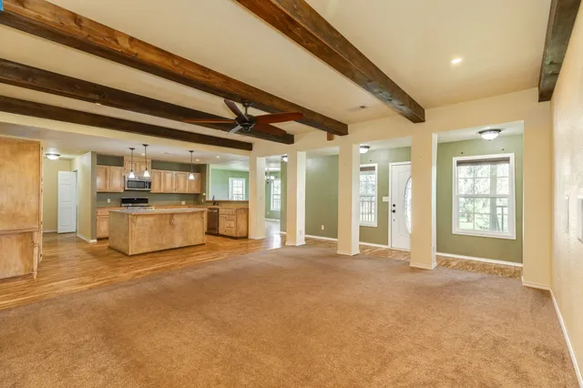 a view of an empty room with a kitchen