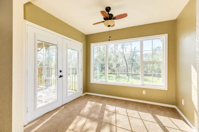 a view of an empty room and a window