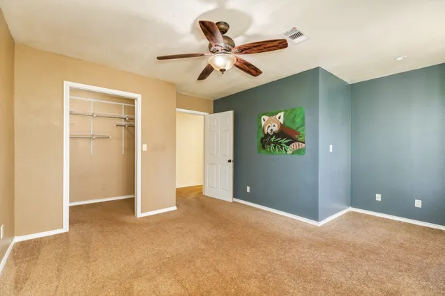 a view of room with window and ceiling fan