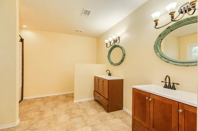 a bathroom with a sink mirror and vanity
