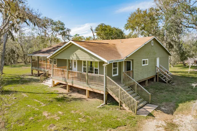 a view of a balcony with wooden floor and fence