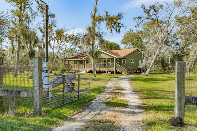 a front view of a house with a yard table and chairs