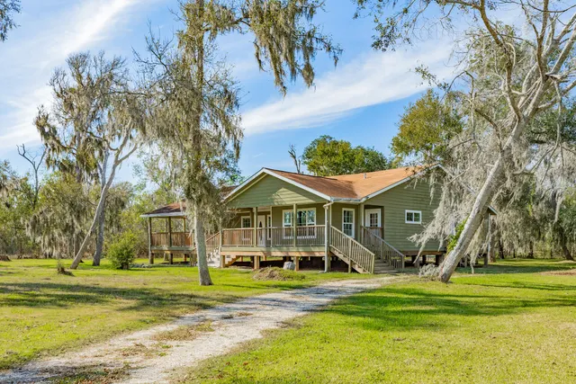 a front view of a house with a big yard