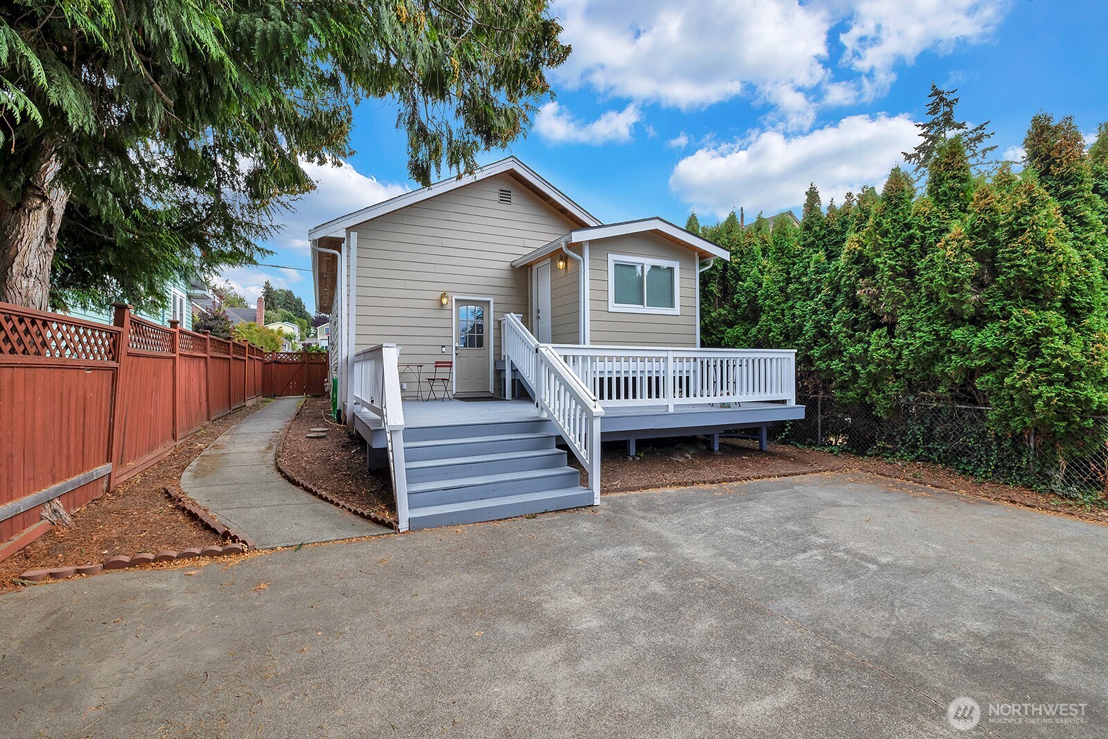 a view of backyard with deck and outdoor seating