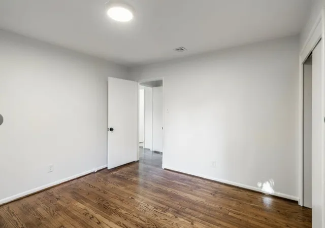 a view of an empty room and wooden floor