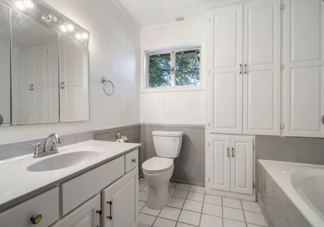 a bathroom with a sink toilet and tub