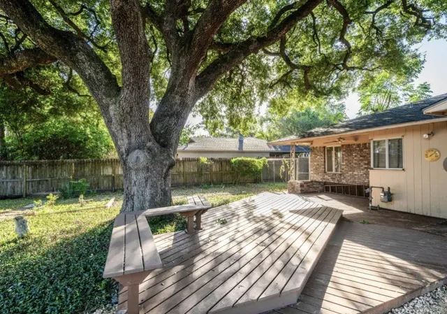 a view of a house with backyard and sitting area