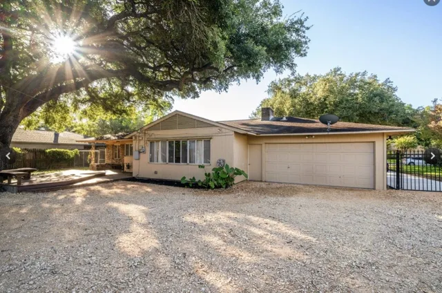 a view of a house with a large tree and a big yard
