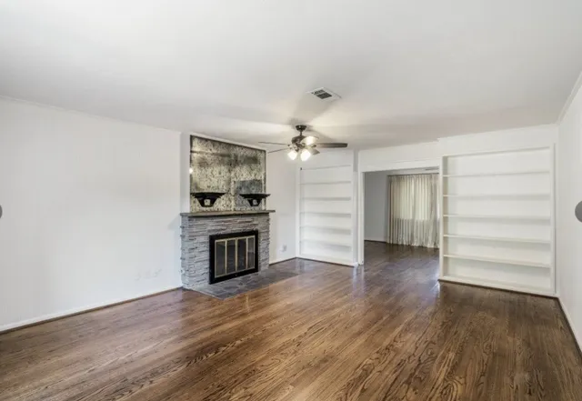 a view of a kitchen with wooden floor and electronic appliances