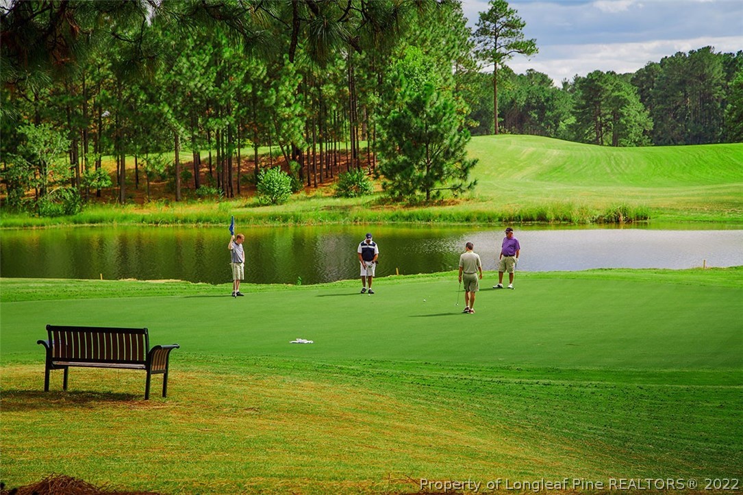 112 Fontana Lake Road Aberdeen, NC 28315 - Photo 7 of 12 a view of a golf course with a lake