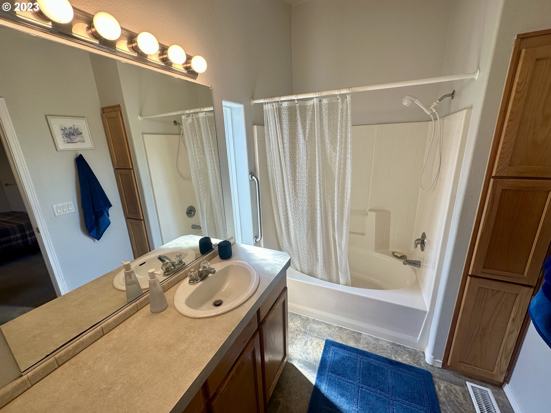 5275 Bridgewater Drive Eugene, OR 97402 - Photo 12 of 18 a bathroom with a sink a mirror a vanity and shower