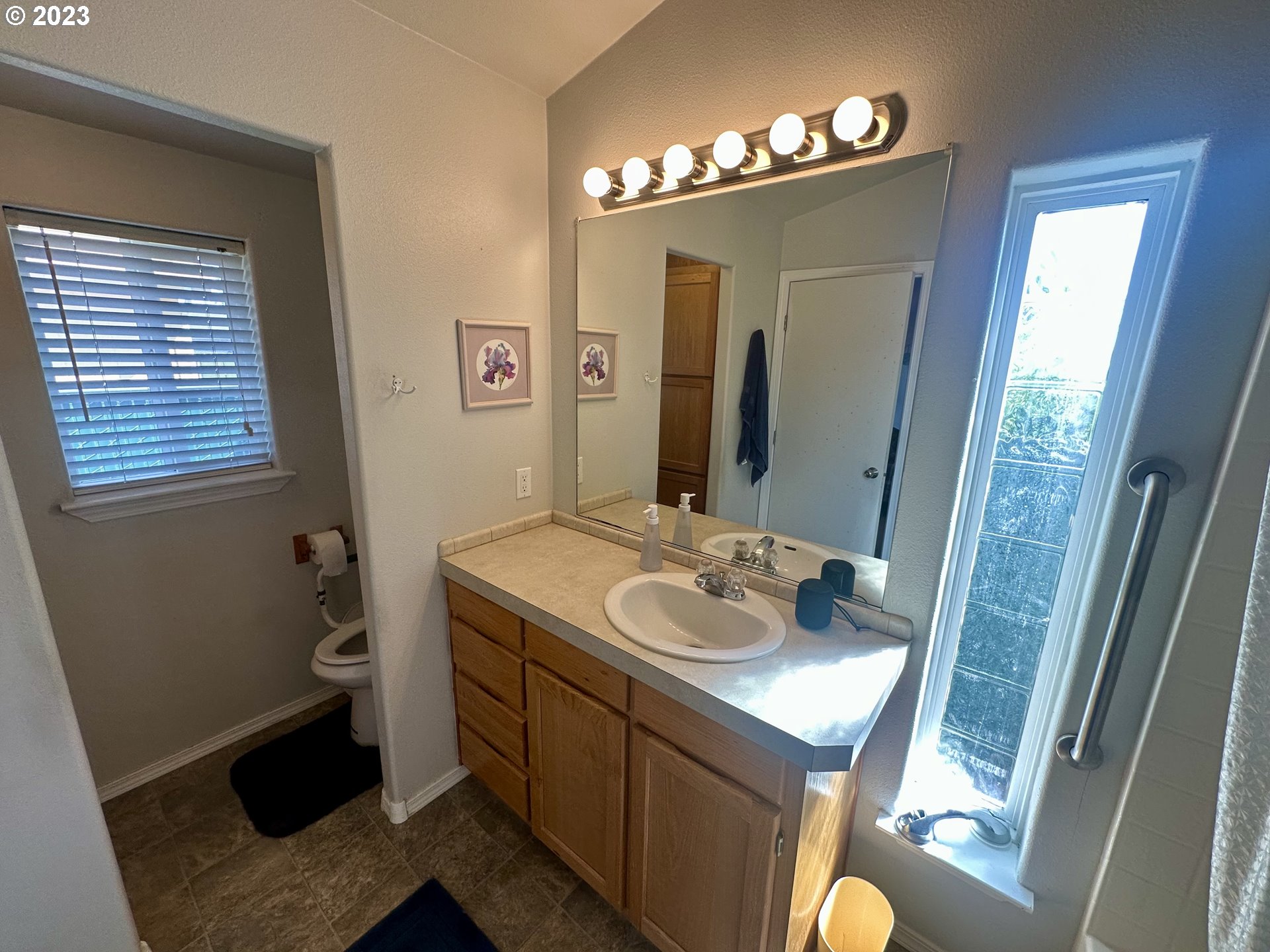 5275 Bridgewater Drive Eugene, OR 97402 - Photo 13 of 18 a bathroom with a granite countertop sink and a mirror